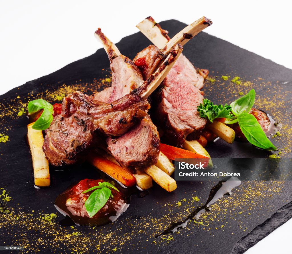 roasted lamb rack served with carrot, yellow curry and lamb sauce